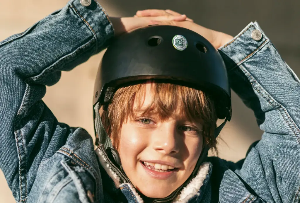 A Lost and Found Label on a child's black helmet.