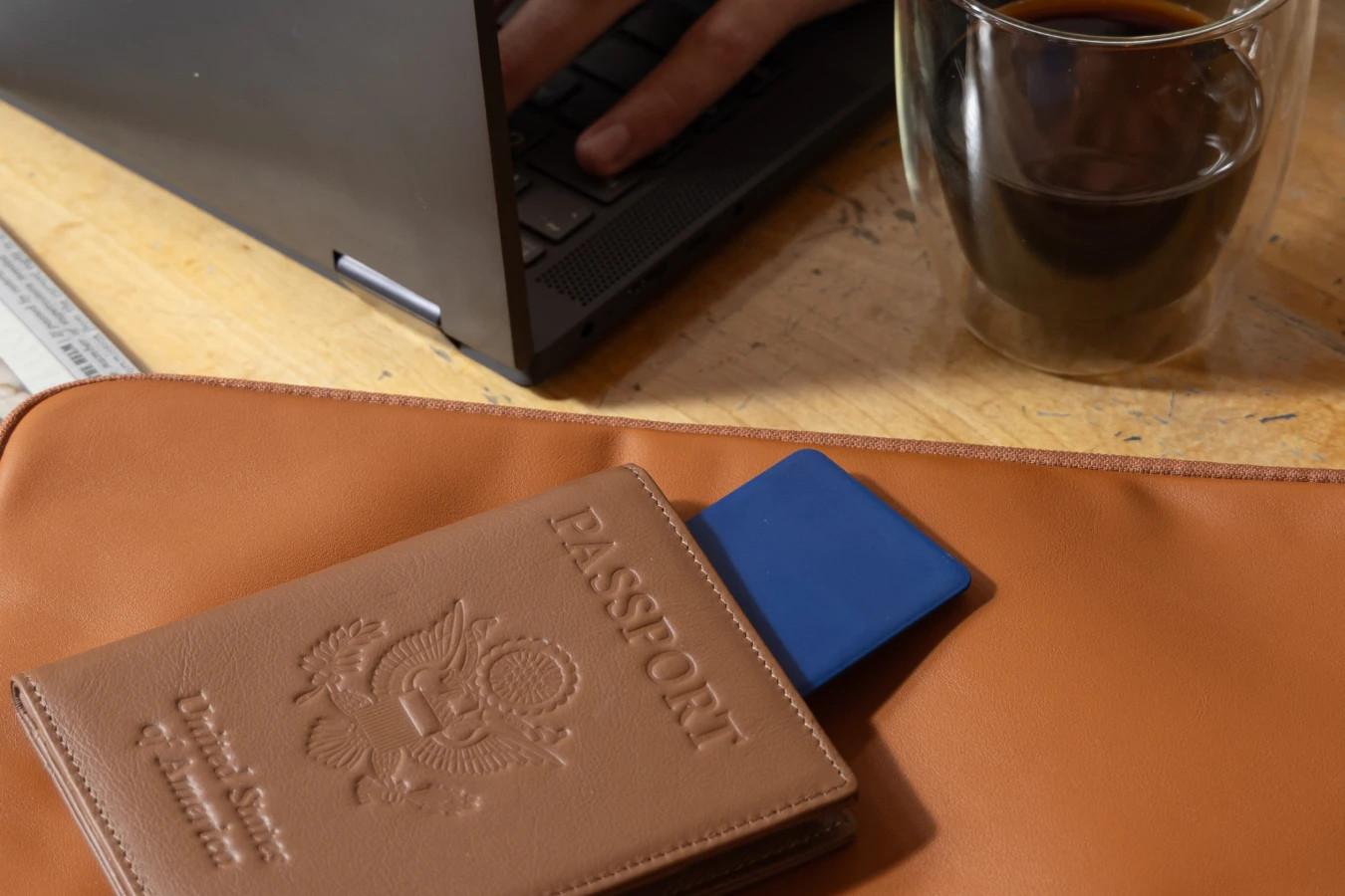 A Life360 Tile Slim - Navy Blaze inside of a passport.