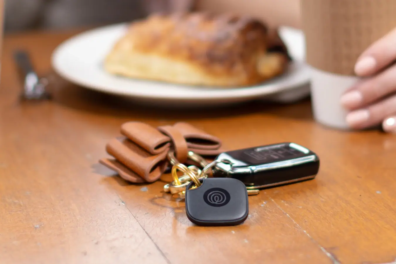 A Life360 Tile attached to a set of keys.