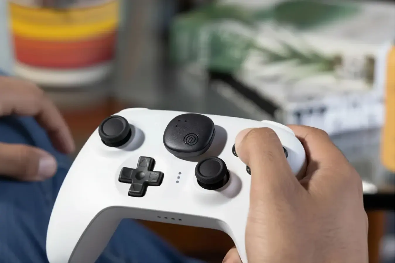 A Life360 Tile Sticker - Black placed on a white wireless controller.