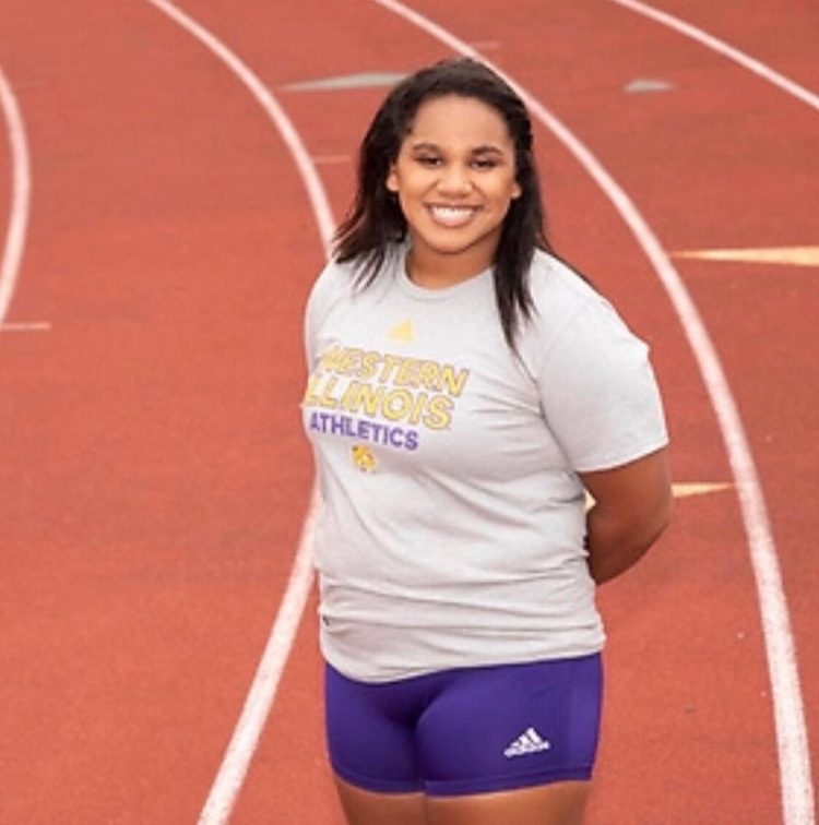 Collegiate track athlete smiling on a track