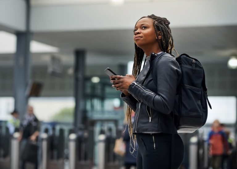 Woman at the airport holding her cellphone
