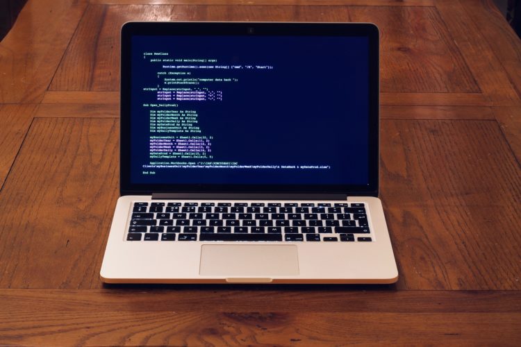 Macbook with software coding on screen