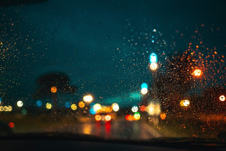 A blurred, wet road at night time